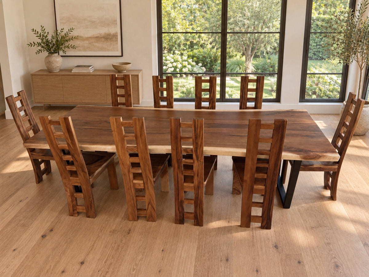 Natural live edge dining table with ten wooden ladder-back chairs in a digitally staged garden-view room