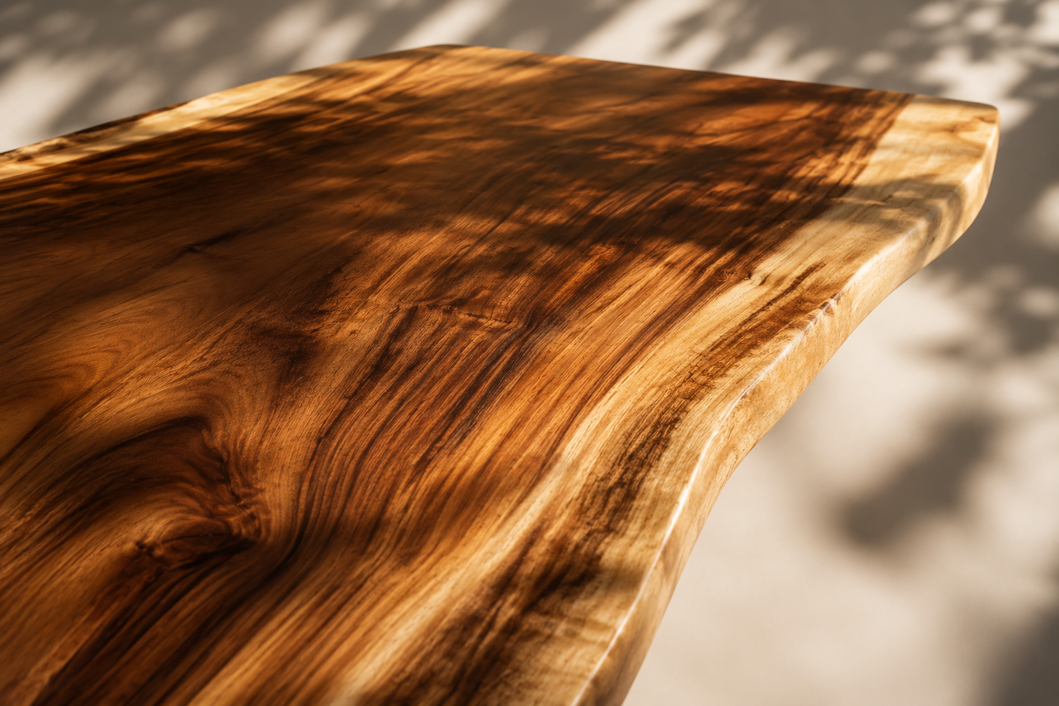 Close-up of polished live edge wood grain in warm sunlight