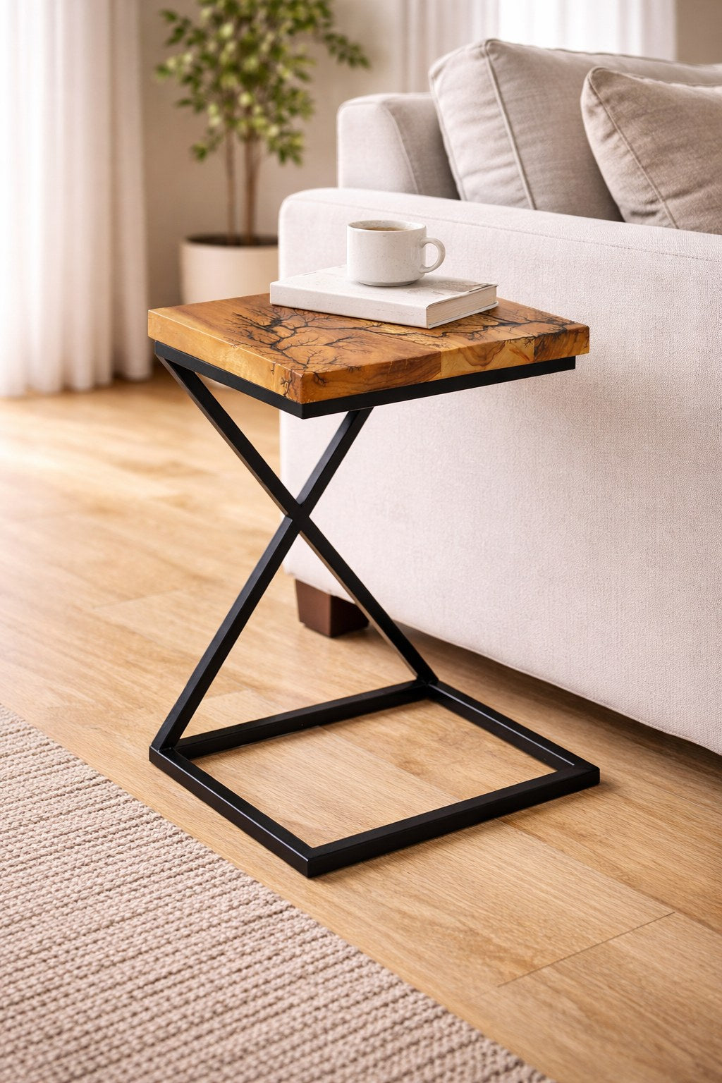 Vella rectangular side table with X-frame metal base beside a sofa