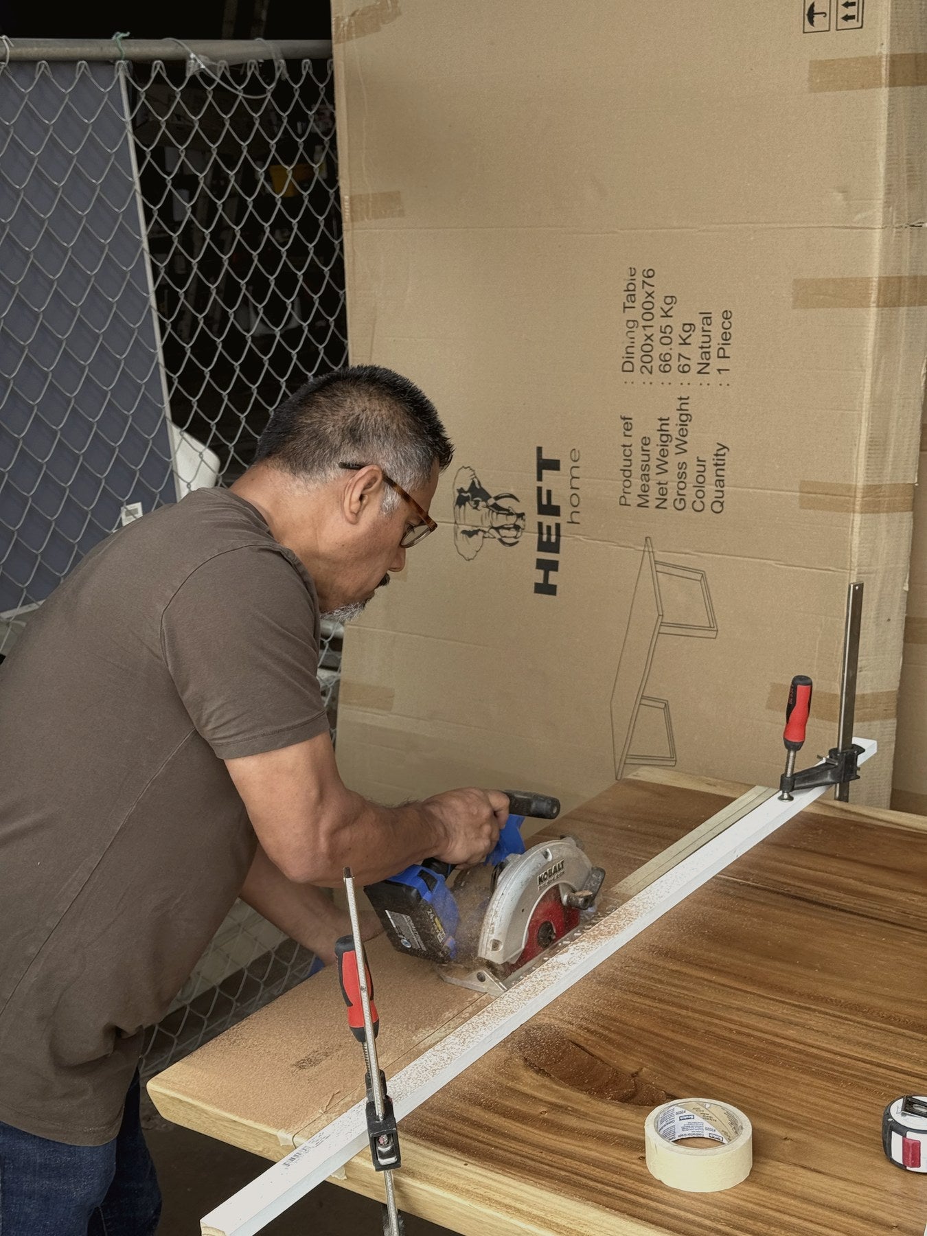 Arturo cutting and fitting a Heft Home live edge dining table in the Irvine workshop